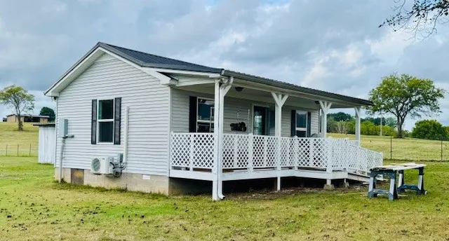 a view of a house with a yard and sitting area