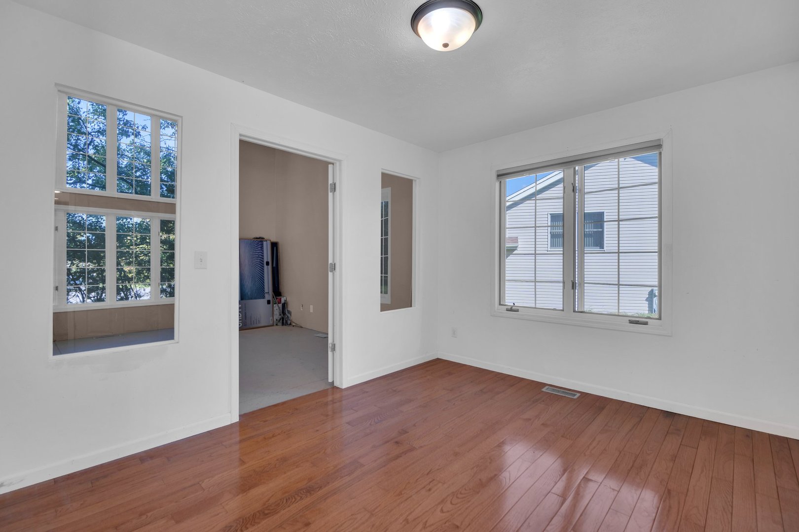 112 Sequoyah Court Southwest Poplar Grove, IL 61065 - Photo 4 of 26 a view of an empty room with wooden floor and a window