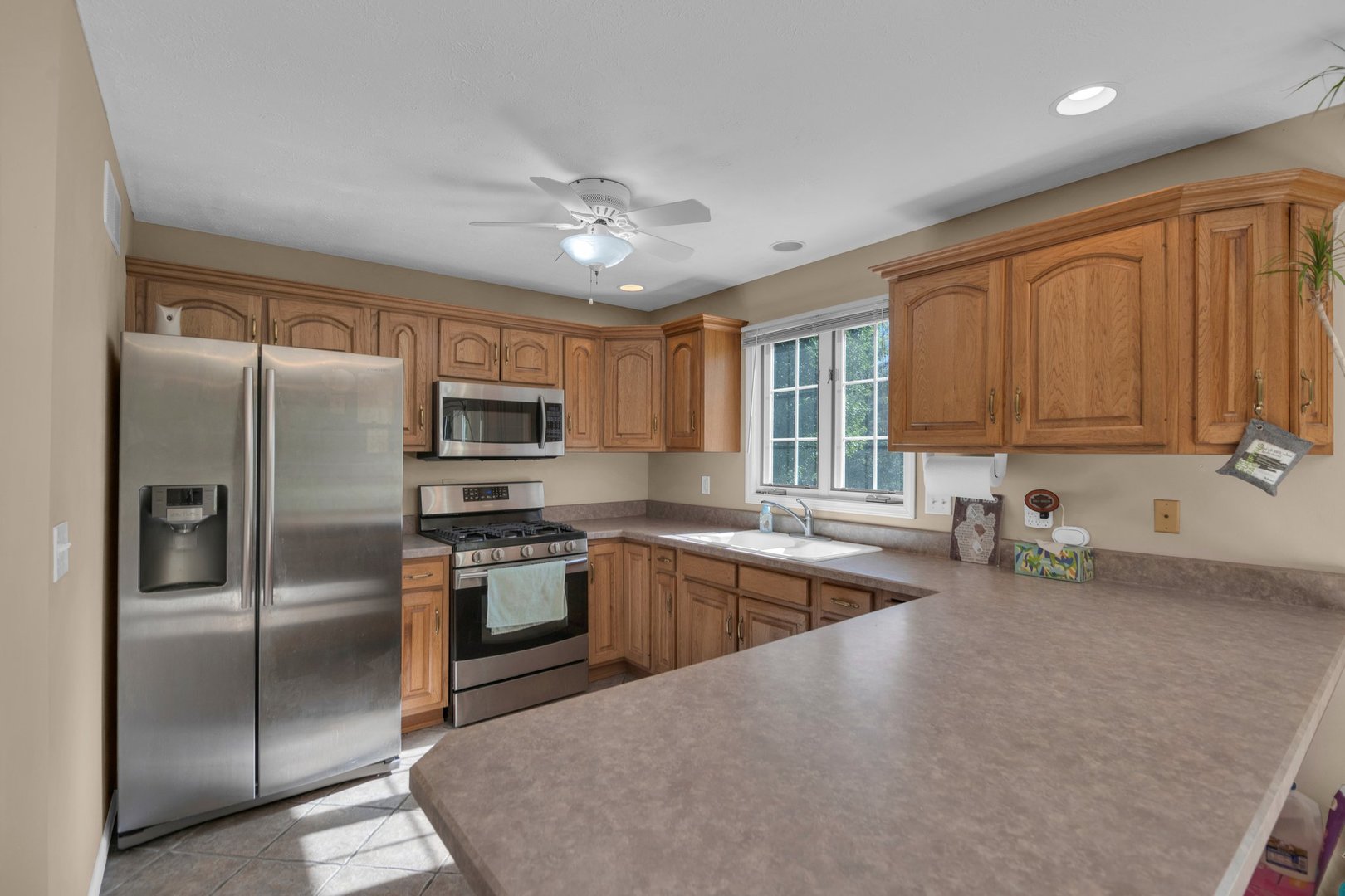 112 Sequoyah Court Southwest Poplar Grove, IL 61065 - Photo 6 of 26 a kitchen with stainless steel appliances granite countertop a refrigerator a stove a sink and dishwasher
