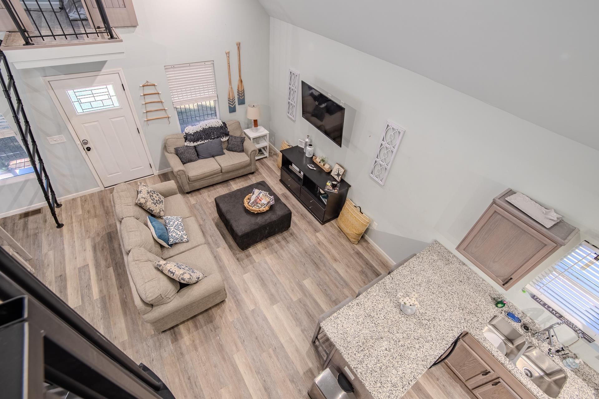 25 Bogey Loop Counce, TN 38326 - Photo 18 of 37 Living area with plenty of natural light, a towering ceiling, and light wood-style floors