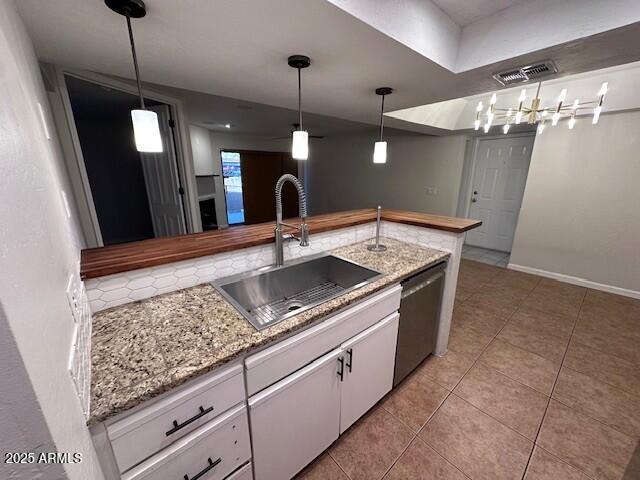 2935 North 68th Street, Unit 127 Scottsdale, AZ 85251 - Photo 3 of 25 a kitchen with stainless steel appliances granite countertop a sink a counter space and cabinets
