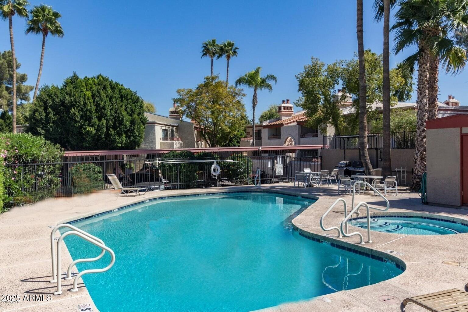 2935 North 68th Street, Unit 127 Scottsdale, AZ 85251 - Photo 7 of 25 a view of a swimming pool with chairs