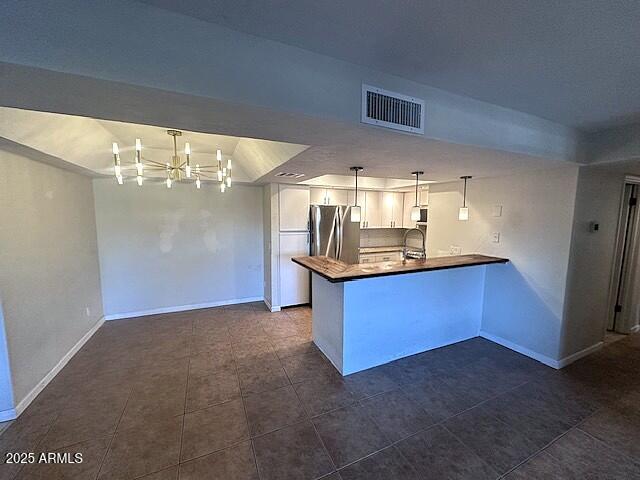 2935 North 68th Street, Unit 127 Scottsdale, AZ 85251 - Photo 8 of 25 a kitchen with stainless steel appliances kitchen island granite countertop a stove and cabinets