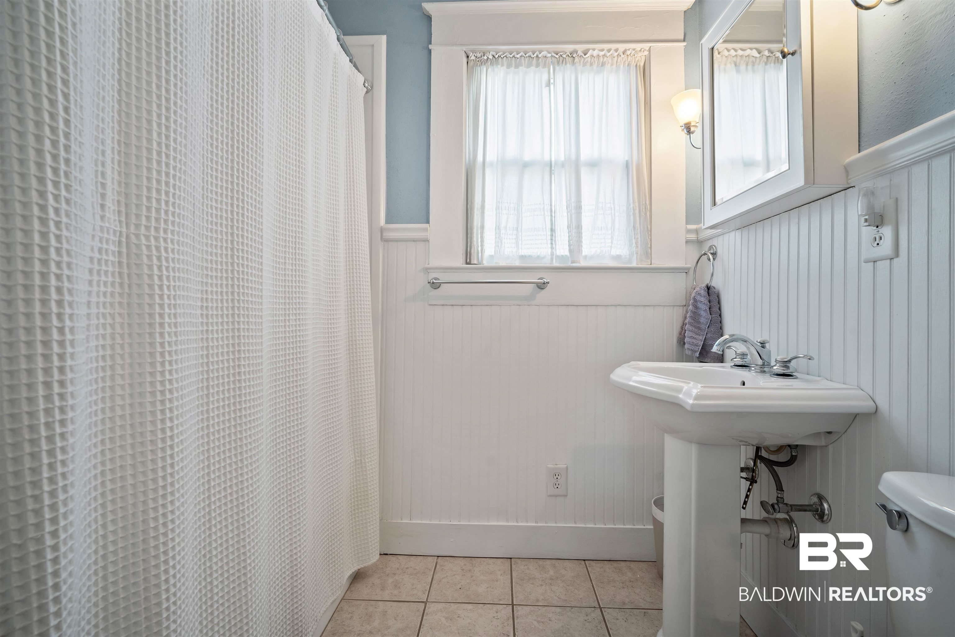 168 Mohawk Street Mobile, AL 36606 - Photo 21 of 31 Bathroom featuring a wainscoted wall, curtained shower, and light tile patterned floors
