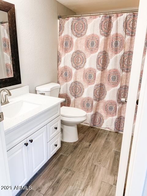 1051 South Dobson Road, Unit 168 Mesa, AZ 85202 - Photo 4 of 9 a bathroom with a double vanity sink mirror and toilet