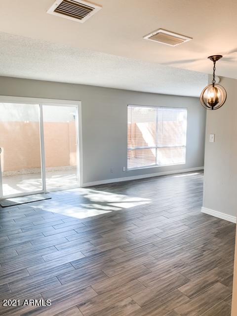 1051 South Dobson Road, Unit 168 Mesa, AZ 85202 - Photo 6 of 9 an empty room with wooden floor and windows