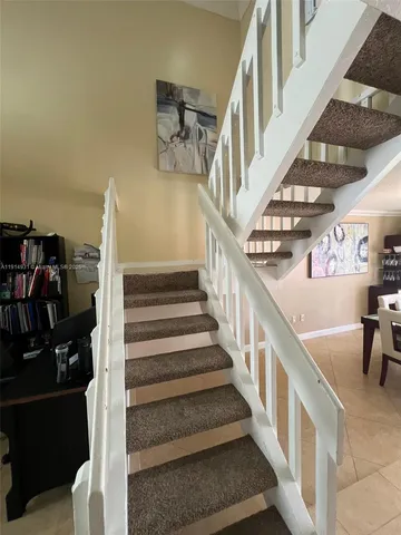a spacious bedroom with a bed and a chandelier