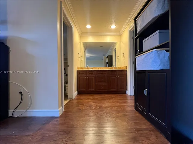 a white toilet sitting next to a bathroom sink and vanity