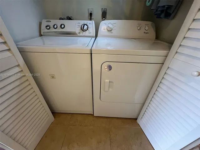 a view of a patio with table and chairs under an umbrella