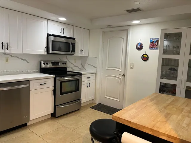 a dining room with furniture and a lamp