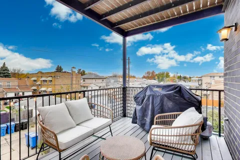a view of a balcony with furniture