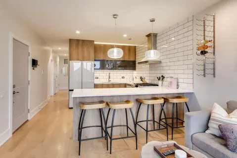 a kitchen with a table chairs refrigerator and microwave