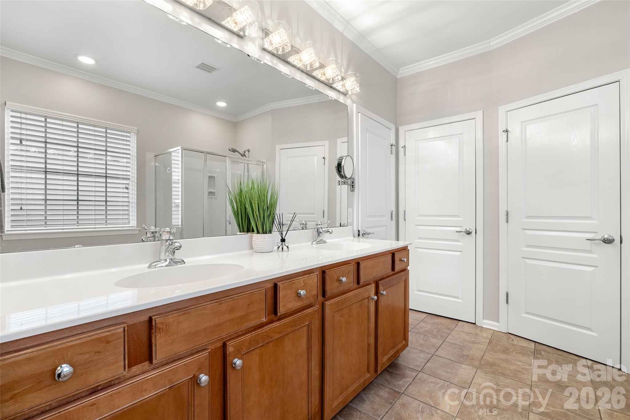 10564 Bethpage Drive Fort Mill, SC 29707 - Photo 19 of 47 a bathroom with a double vanity sink a mirror and a bathtub