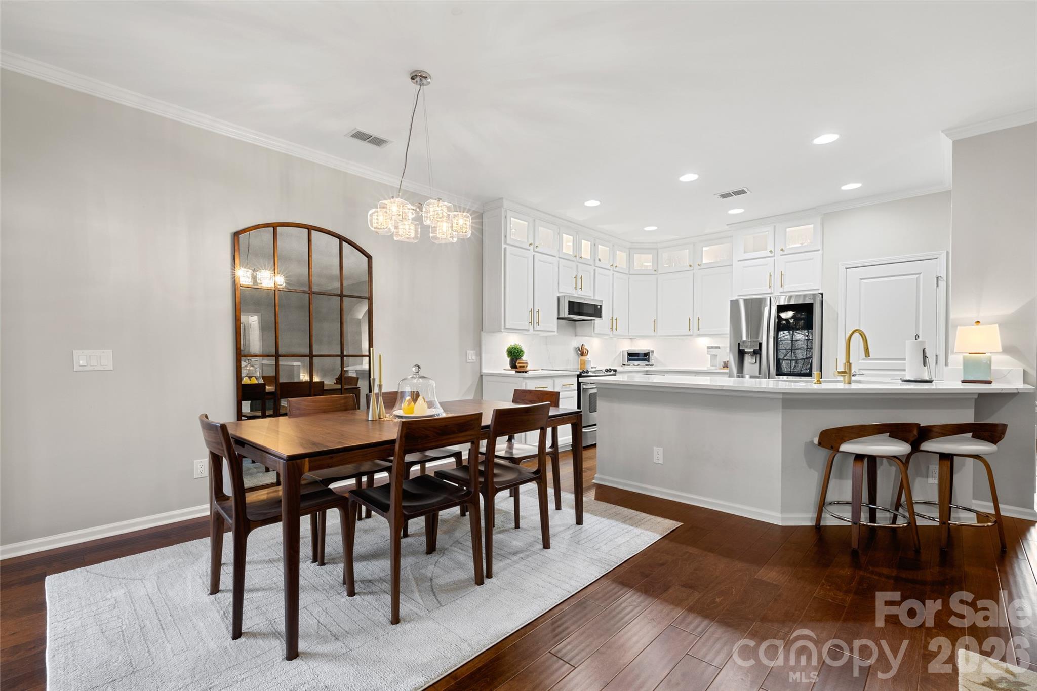 10564 Bethpage Drive Fort Mill, SC 29707 - Photo 8 of 47 a kitchen with stainless steel appliances granite countertop a dining table chairs and stove top oven