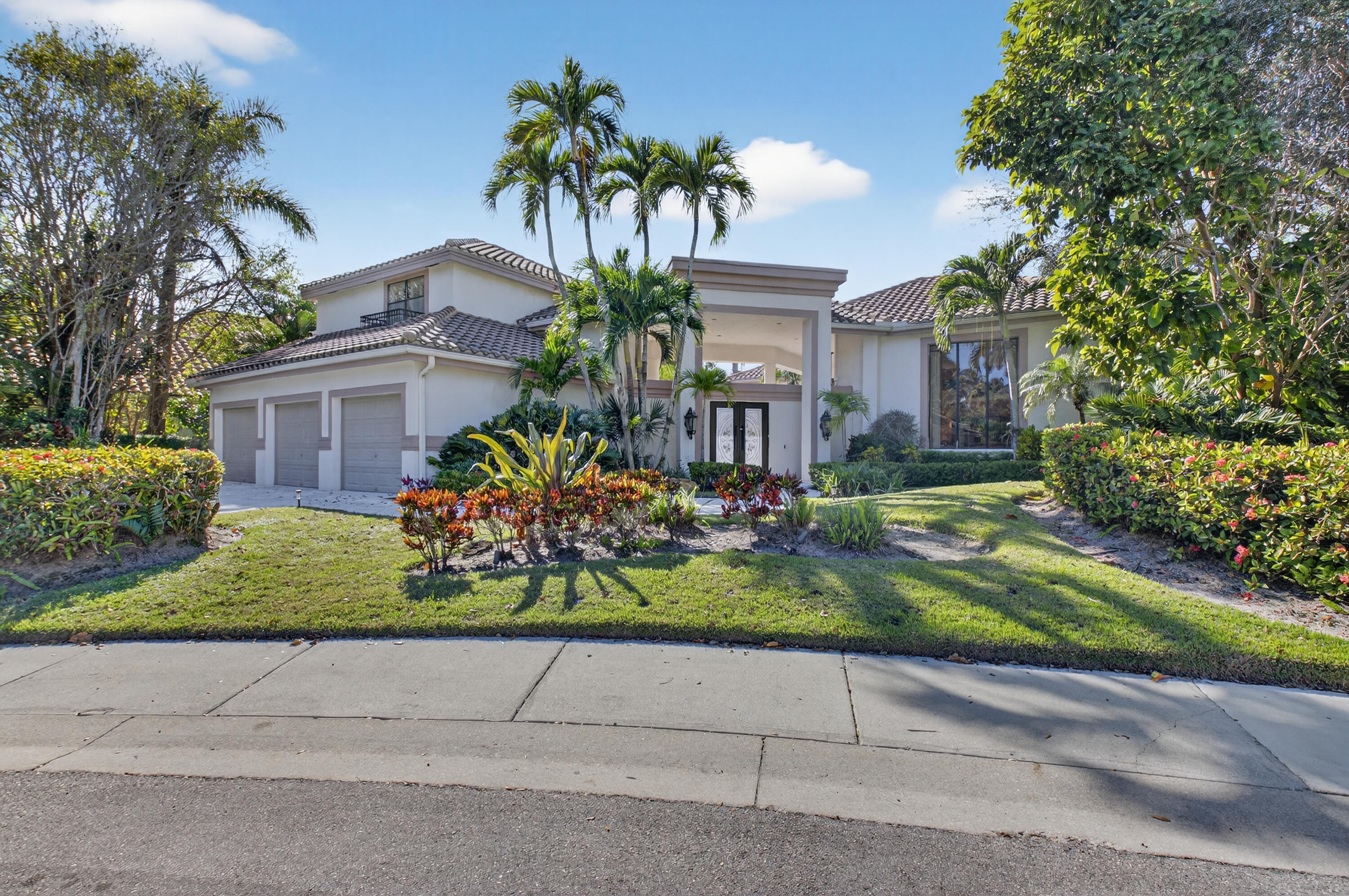 a front view of a house with a yard and a garage