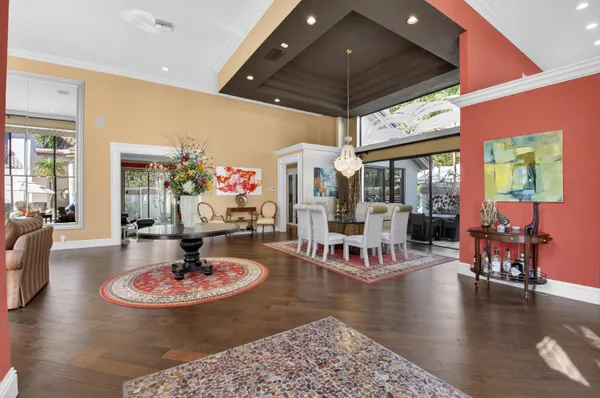 a dining room with furniture a rug and wooden floor