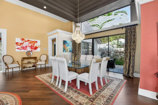 a view of a dining room with furniture wooden floor and a chandelier