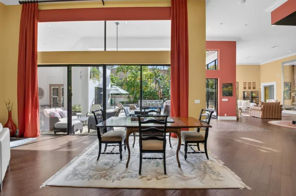 a living room with fireplace furniture large windows and a flat screen tv