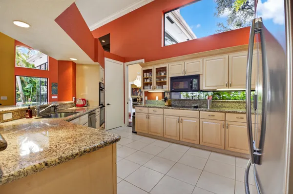 a kitchen with stainless steel appliances granite countertop a stove and cabinets