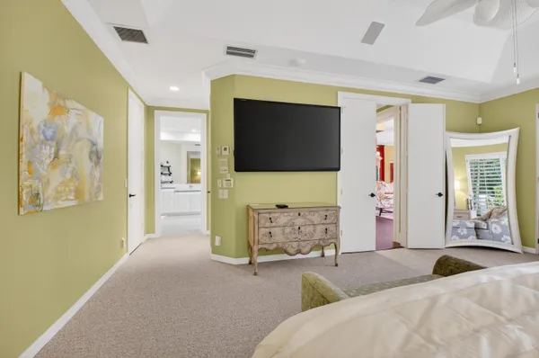 a bedroom with a bed and a chandelier