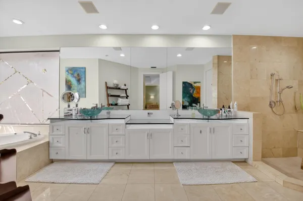 a bathroom with a granite countertop sink toilet and mirror