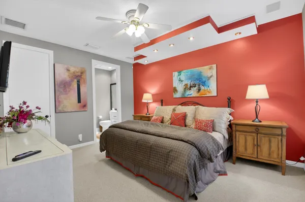 a living room with furniture a flat screen tv and a large window