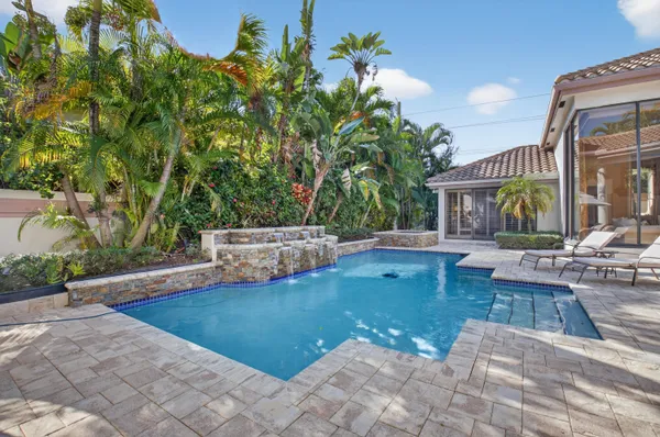 a view of a house with backyard and sitting area