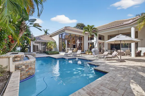 a view of a patio with swimming pool table and chairs