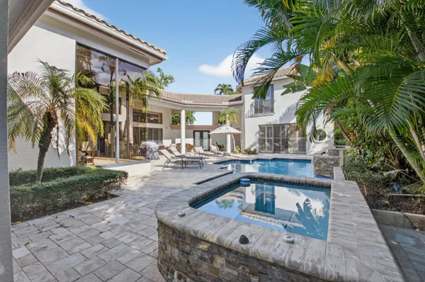a view of a house with backyard and sitting area