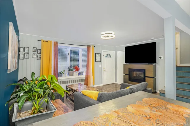 a living room with fireplace furniture and a flat screen tv