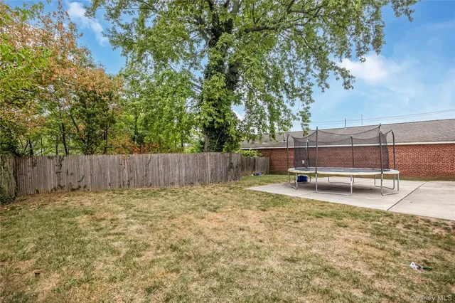 a view of a backyard with a small cabin and a chair