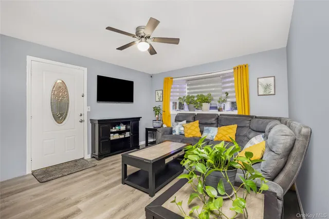 a living room with furniture a fireplace and a flat screen tv