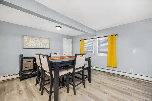 a view of a dining room with furniture and a window