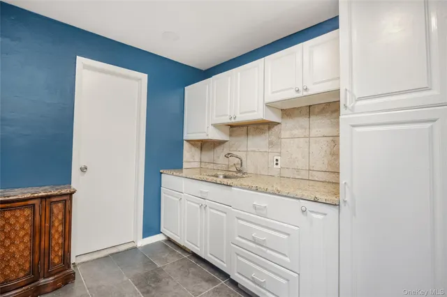 a kitchen with appliances cabinets and a sink