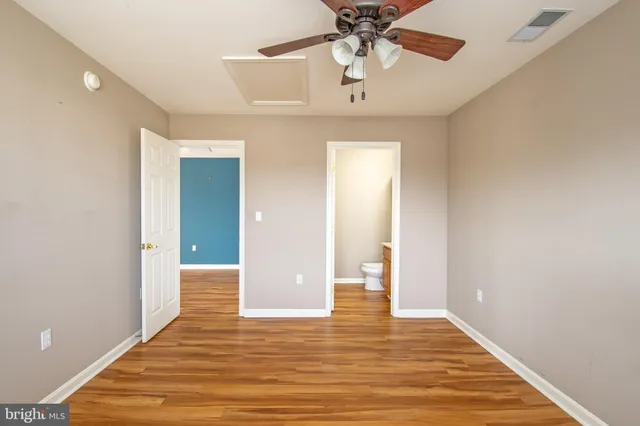 a view of an empty room and wooden floor