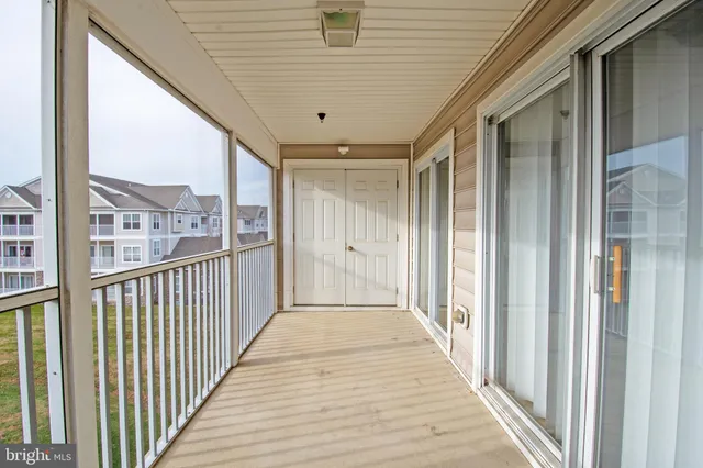 a view of a porch with wooden floor and stairs