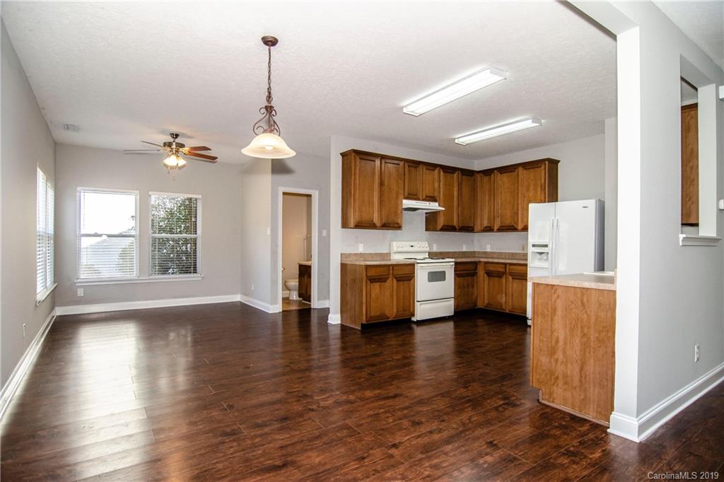 14232 Luscombe Farm Road Charlotte, NC 28278 - Photo 12 of 29 a kitchen that has a lot of cabinets and a wooden floor