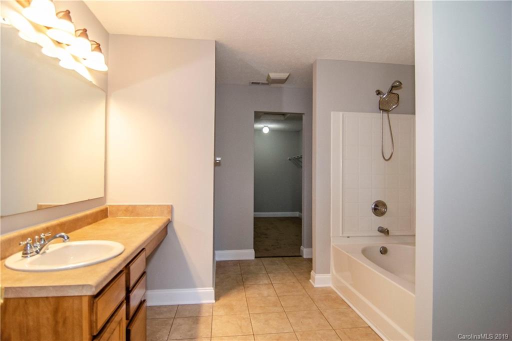 14232 Luscombe Farm Road Charlotte, NC 28278 - Photo 21 of 29 a bathroom with a tub sink and mirror