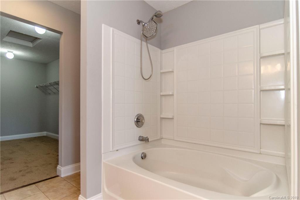 14232 Luscombe Farm Road Charlotte, NC 28278 - Photo 23 of 29 a white bath tub sitting next to a shower
