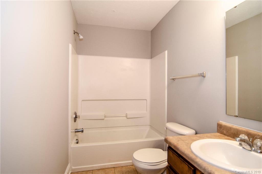 14232 Luscombe Farm Road Charlotte, NC 28278 - Photo 26 of 29 a bathroom with a granite countertop bathtub shower sink mirror vanity and toilet