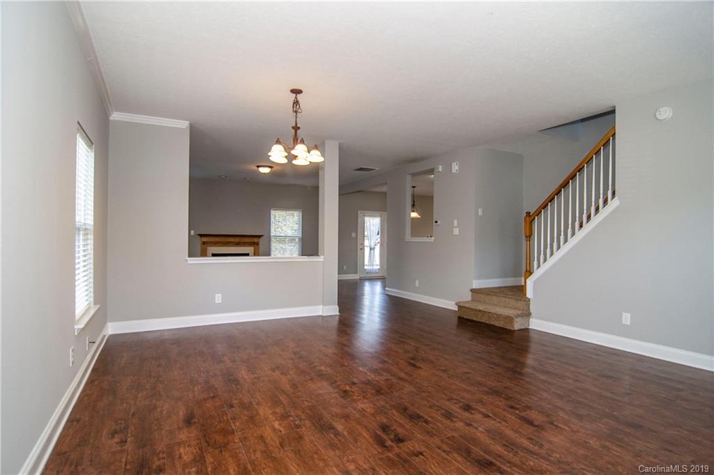 14232 Luscombe Farm Road Charlotte, NC 28278 - Photo 6 of 29 a view of a livingroom with wooden floor and a kitchen space