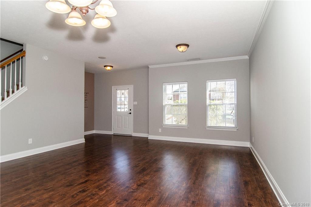 14232 Luscombe Farm Road Charlotte, NC 28278 - Photo 7 of 29 an empty room with wooden floor and windows