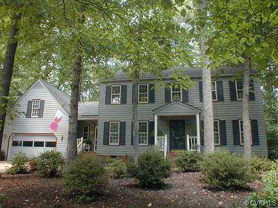 front view of a house next to a yard