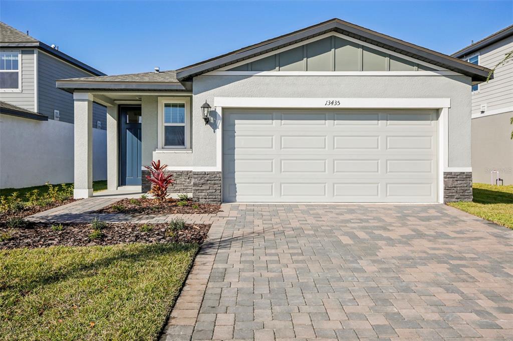 13435 Shellmore Avenue Palmetto, FL 34221 - Photo 1 of 1 a front view of a house with a yard and garage