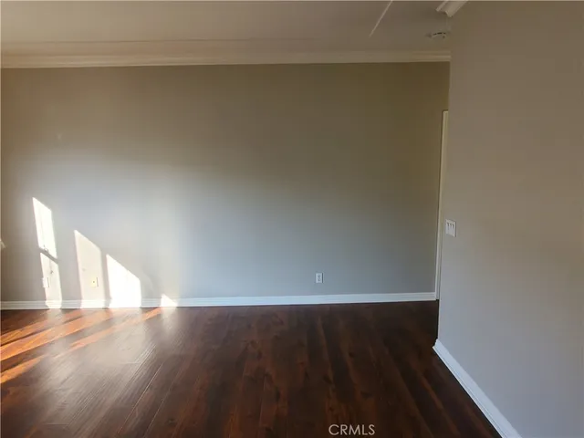 a view of room with window and wooden floor