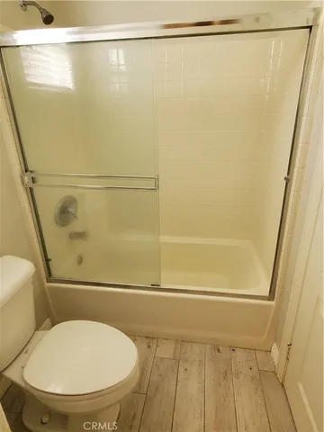 a bathroom with a toilet and a shower
