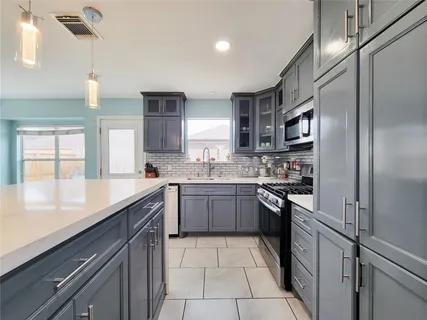 a kitchen with a sink stove and refrigerator