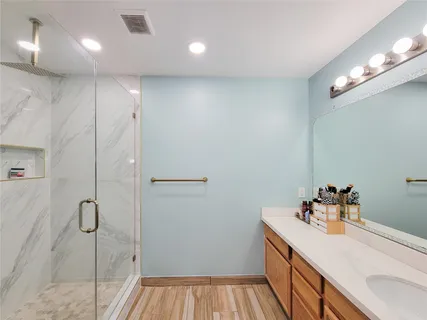 a bathroom with a sink and shower