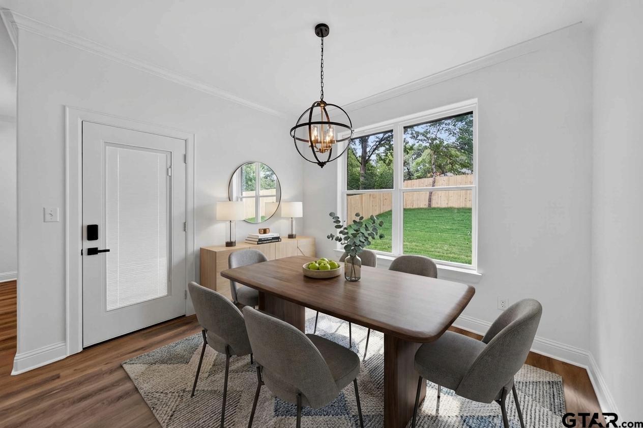 3045 Guinn Farms Road Tyler, TX 75707 - Photo 14 of 45 a view of a dining room with furniture window and wooden floor