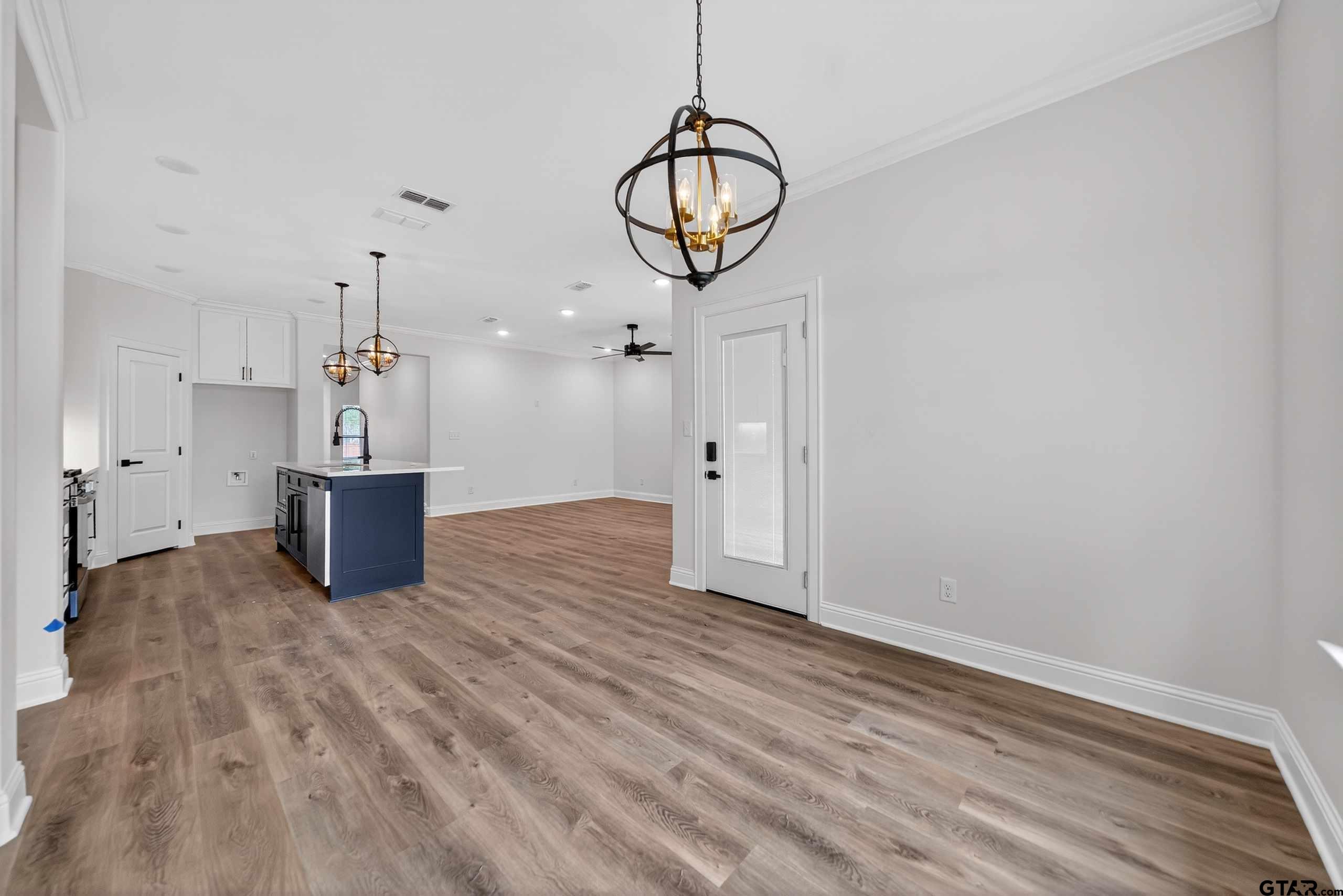 3045 Guinn Farms Road Tyler, TX 75707 - Photo 15 of 45 a view of a kitchen with wooden floor and a sink
